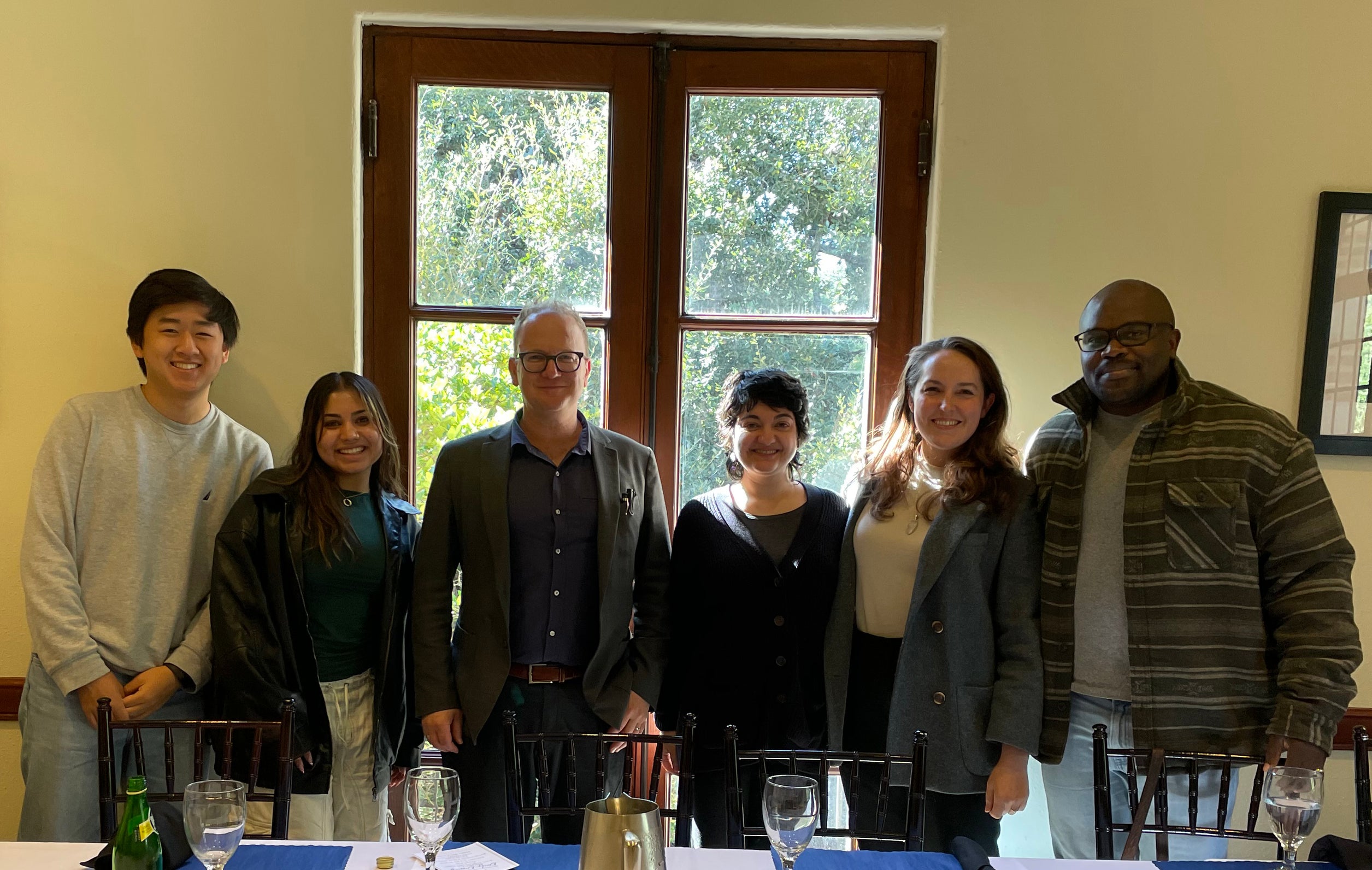 photo of Jeremy Greene with postdocs and students