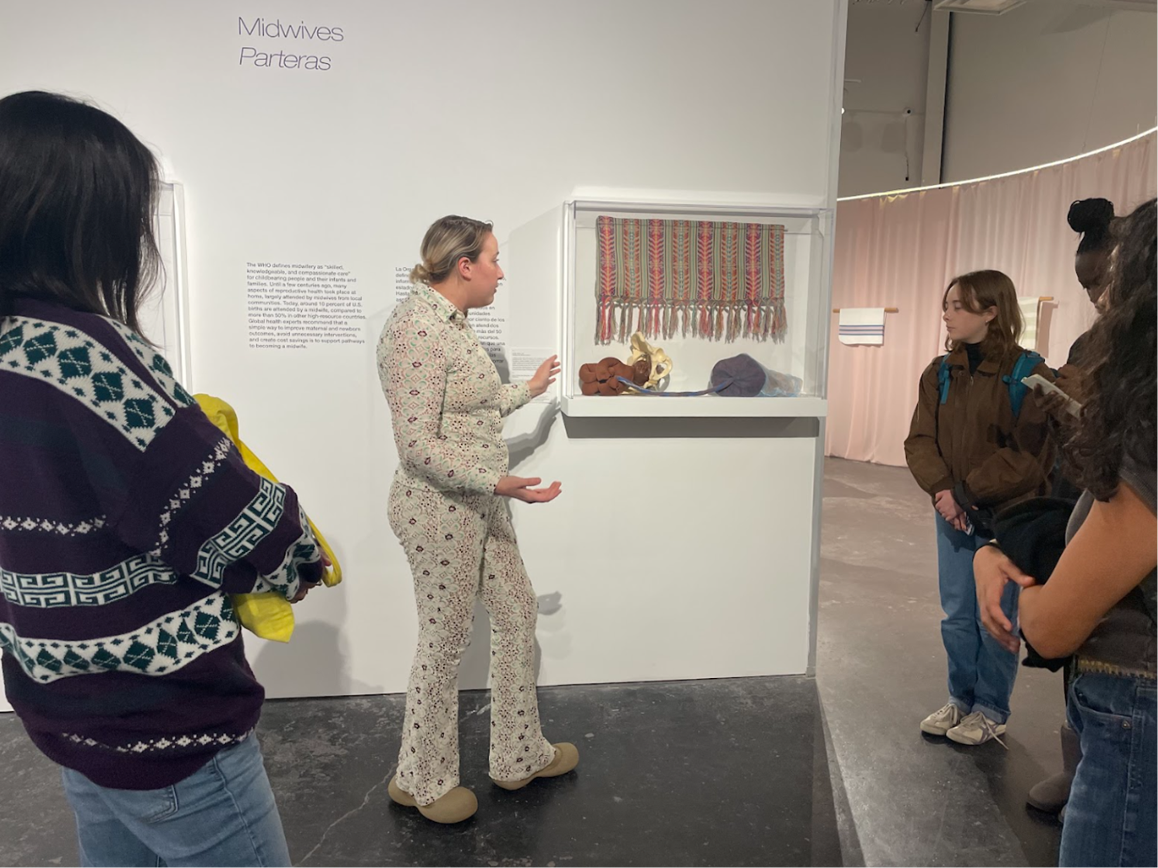 HCCC Exhibitions Director Sarah Darro gives students a tour of the exhibition